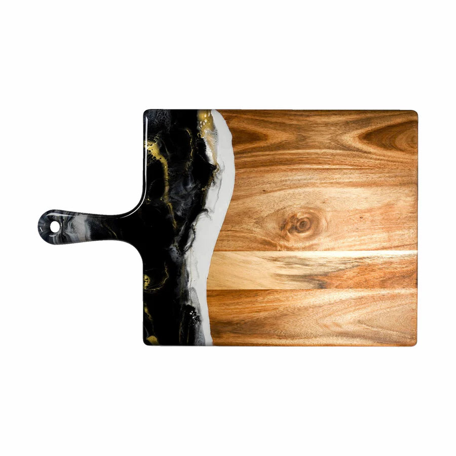 Wooden charcuterie serving tray with black and gold abstract design on a white background