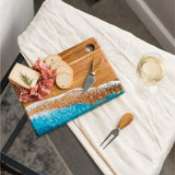 Small acacia wood cheese and charcuterie serving board with glossy resin accent