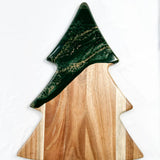 Christmas Tree shaped serving board made of acacia wood with green resin accent, styled with holiday snacks.