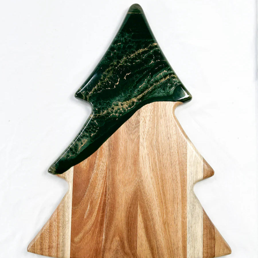 Christmas Tree shaped serving board made of acacia wood with green resin accent, styled with holiday snacks.