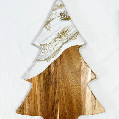 Christmas Tree shaped serving board made of acacia wood with green resin accent, styled with holiday snacks.