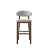 Mid-century modern bar stool with curved beige upholstered backrest and seat, supported by solid dark wood legs and footrest, shown from front