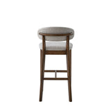 Mid-century modern 30-inch bar stool with a curved backrest upholstered in textured beige fabric and a dark solid wood frame with footrest bars.