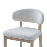 Bar height stool with curved backrest and seat upholstered in textured white fabric, supported by light wood frame with straight legs and clean lines.