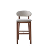 Single mid-century modern bar stool with curved beige upholstered back and seat on solid brown wood legs with horizontal footrest.