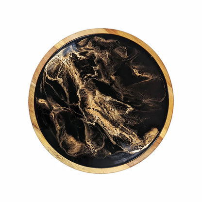 Round resin lazy susan tray with gold and black marbled design on a wooden border
