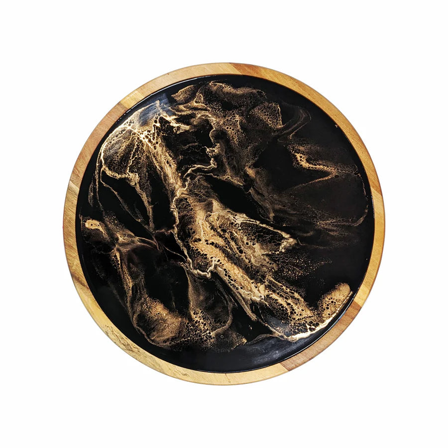 Round resin lazy susan tray with gold and black marbled design on a wooden border