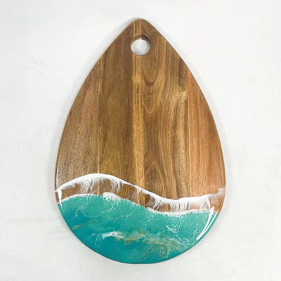 Handcrafted teardrop-shaped acacia wood charcuterie board with ocean-inspired resin design