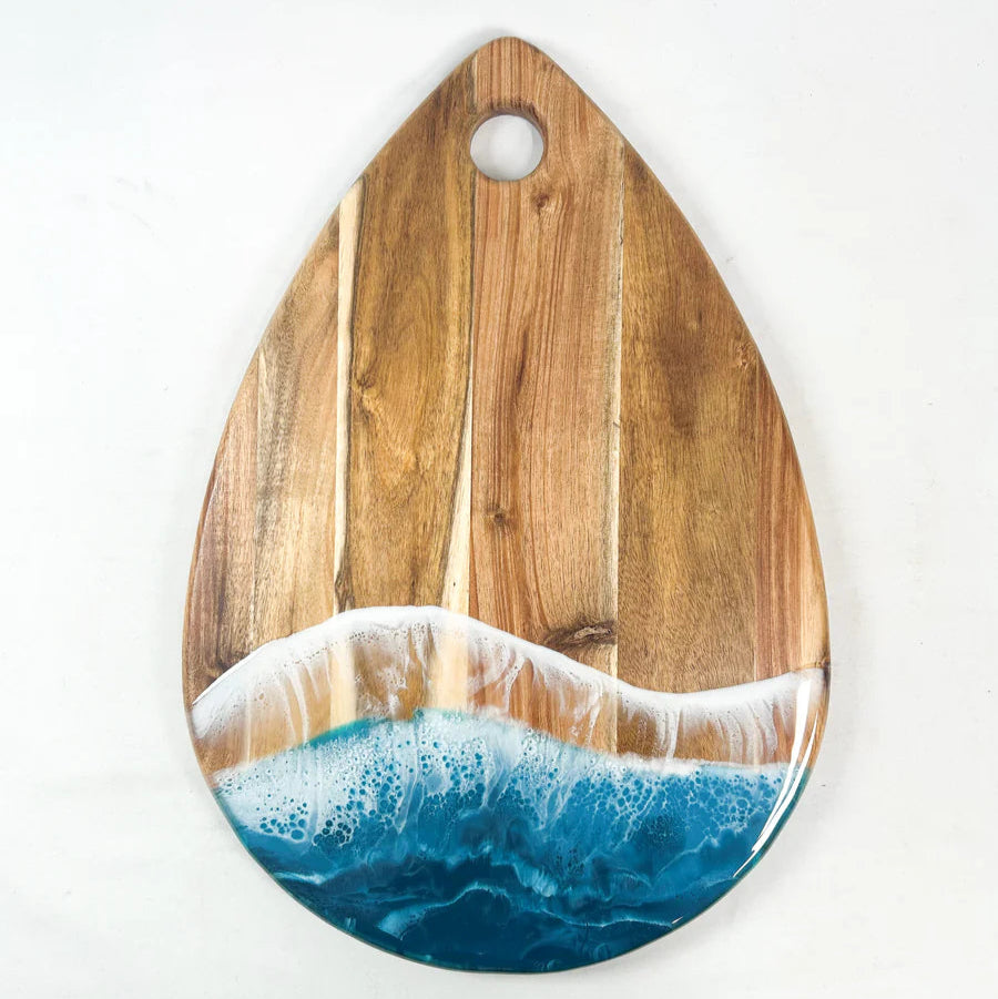 Wooden serving tray with ocean wave design on a white background
