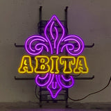 Abita Neon Sign glowing in an indoor setting, mounted on metal grid backing