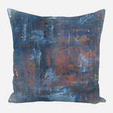 Square pillow with abstract textured design featuring dark blue, rusty red, and gray tones blending in a painterly style.