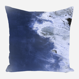 Square pillow with an abstract design featuring deep blue and white shades blending together, resembling a stormy sky or aerial view of water and clouds.