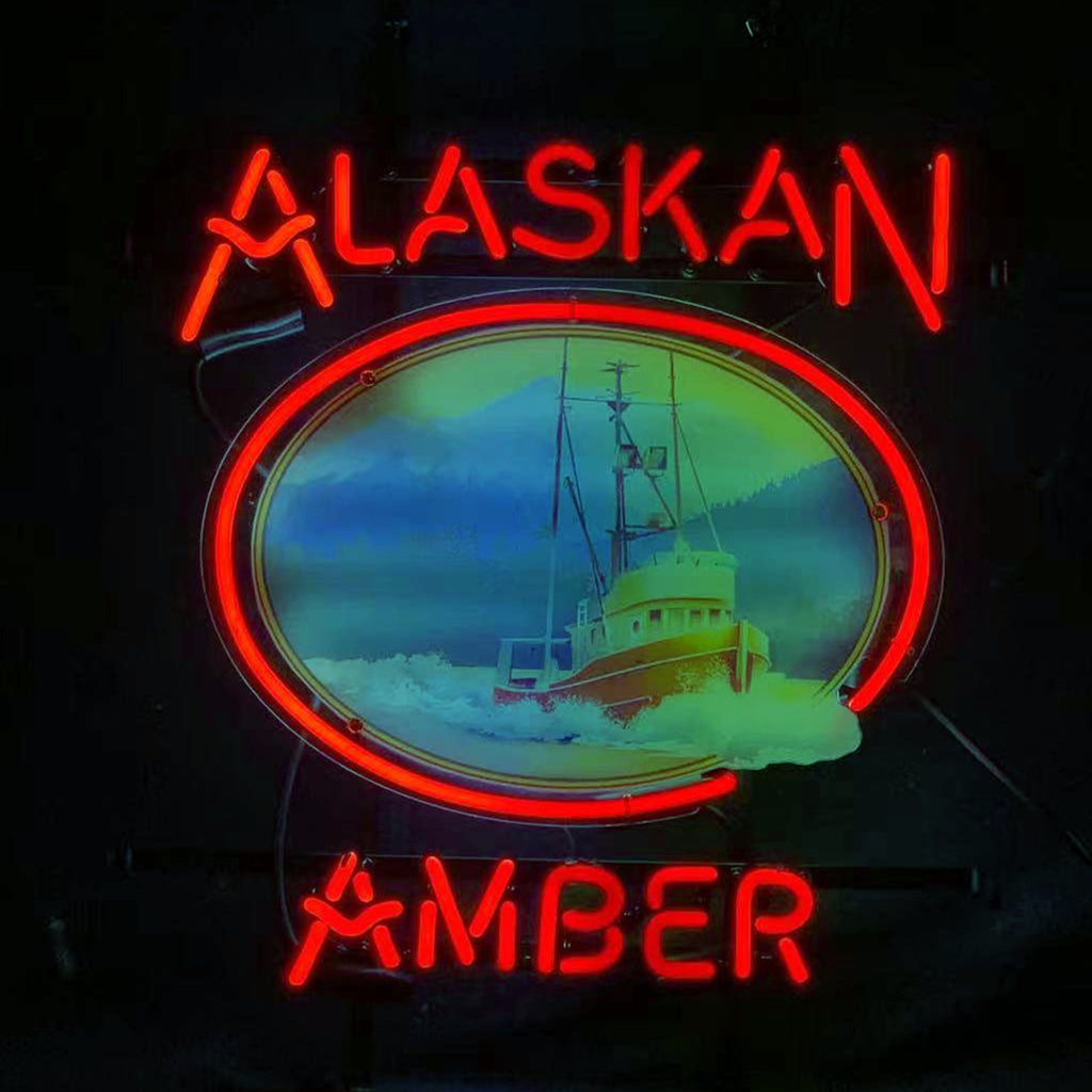 Alaskan Amber Beer Neon Sign glowing on wall with amber light