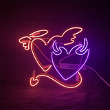 Neon sign with an orange outline angel heart and a purple flame heart intertwined, featuring wings, halo, and tail, glowing brightly against a dark background.