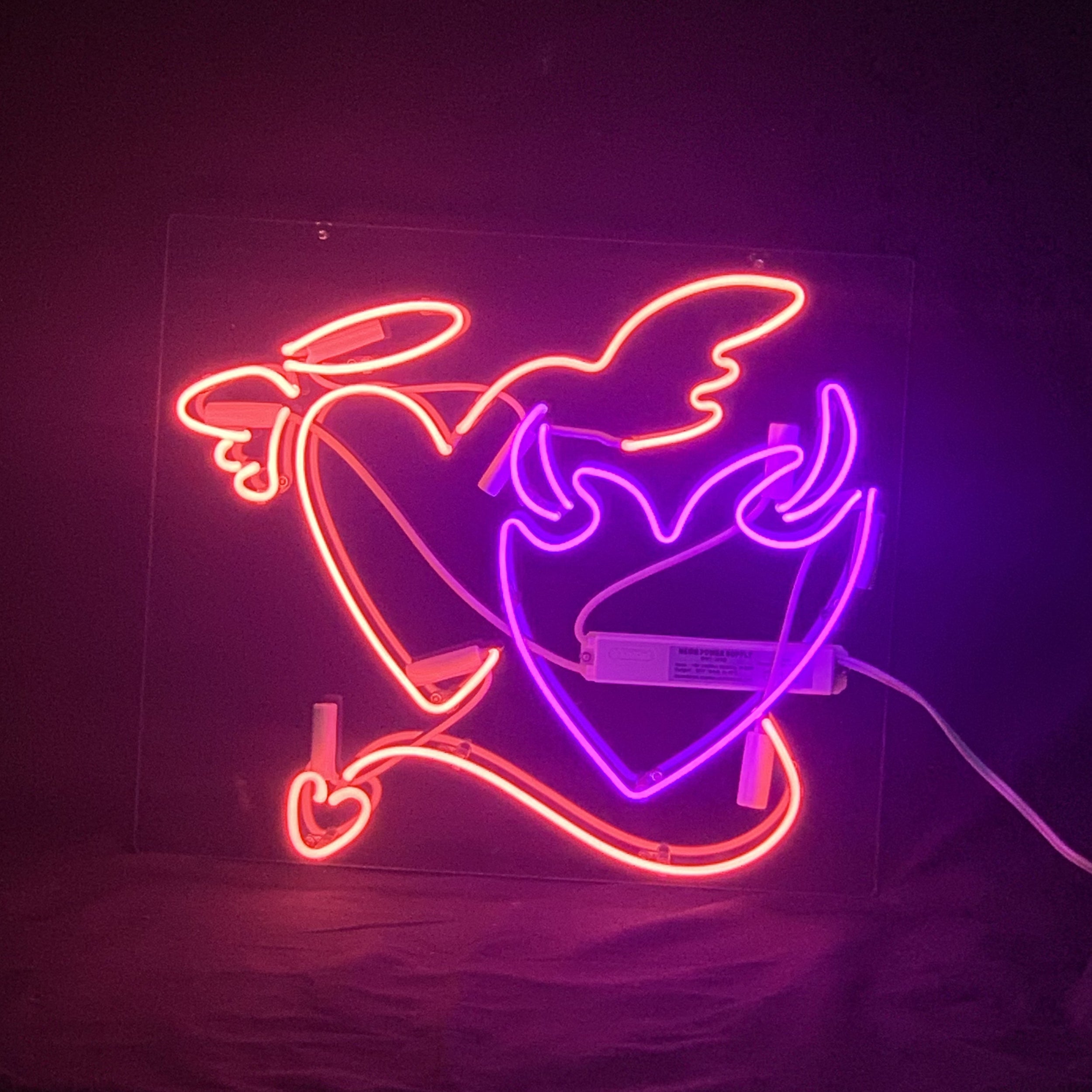 Angels& Demons Heart Neon Signs glowing in red, mounted on acrylic backing