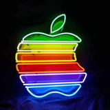 Neon sign shaped like an Apple logo with horizontal stripes in green, yellow, red, purple, and blue colors on a black background.