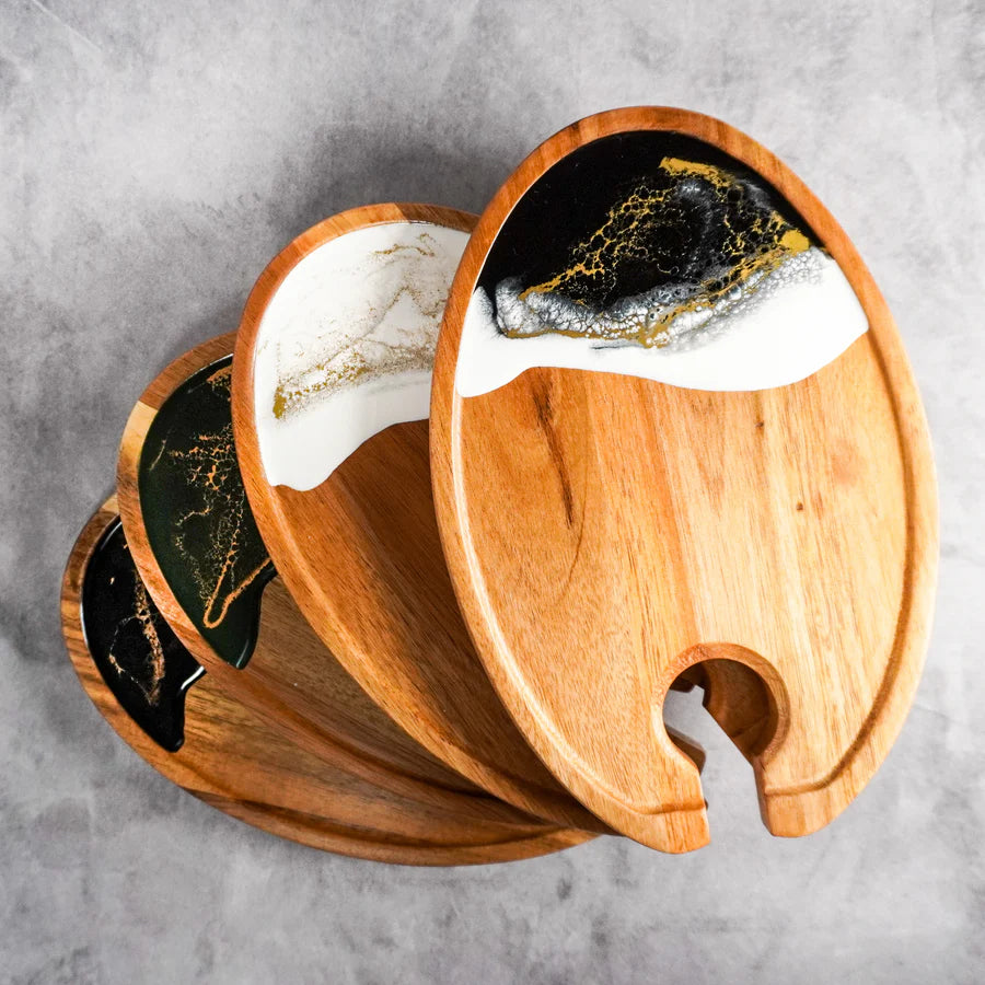Wooden resin Wine & Appetizer Trays  with marble and gold design on a gray surface