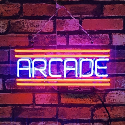 Arcade Neon Signs illuminated hanging on a wall.