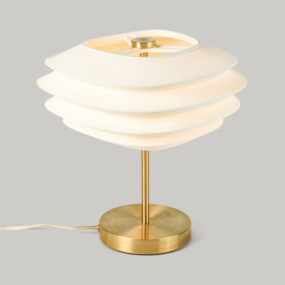 Arcas Lamp by Wooj Design showing a table lamp with complex 3D printed shade and Brass base