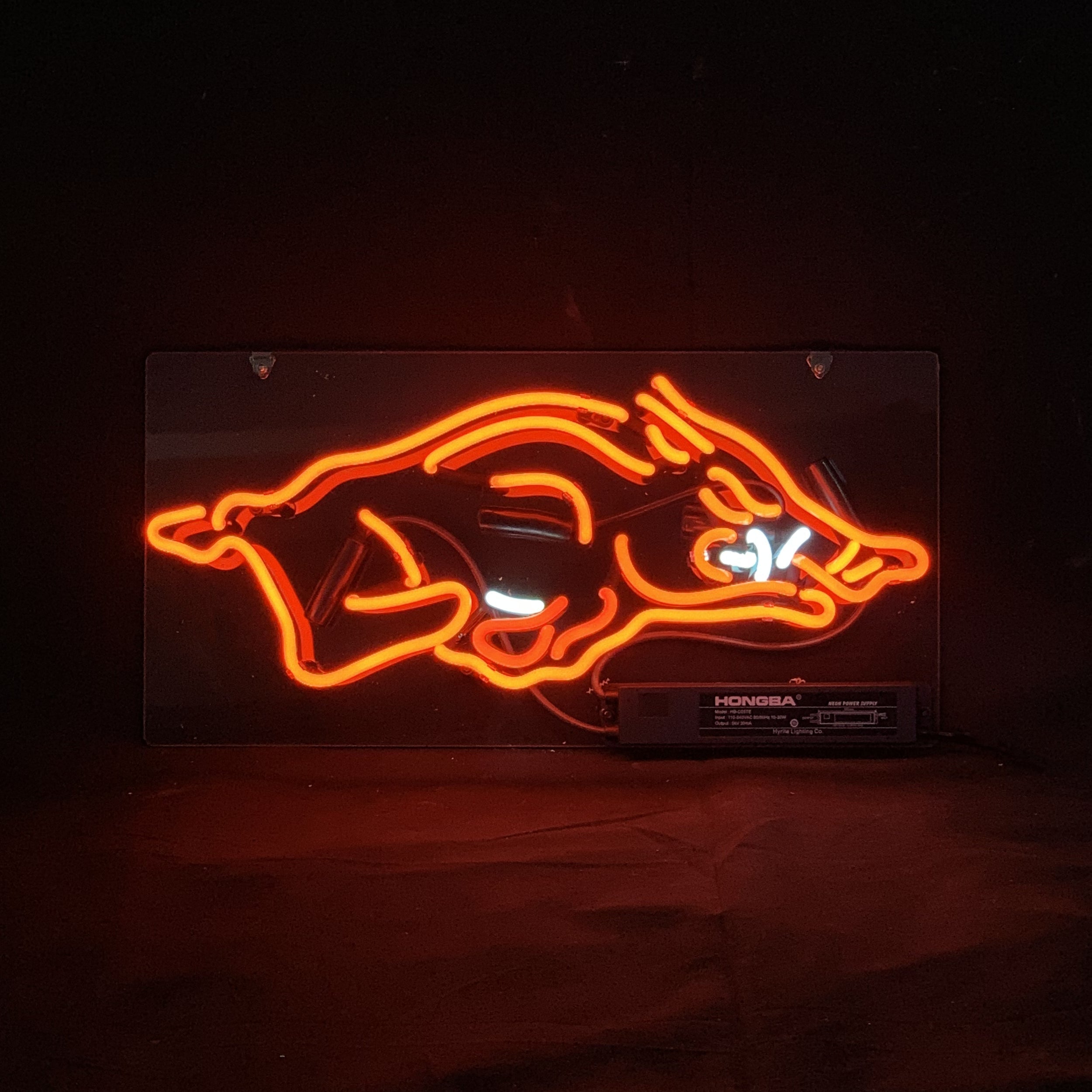 Arkansas Razorbacks Sport Logo Neon Sign Light glowing in red with white accents on metal grid backing