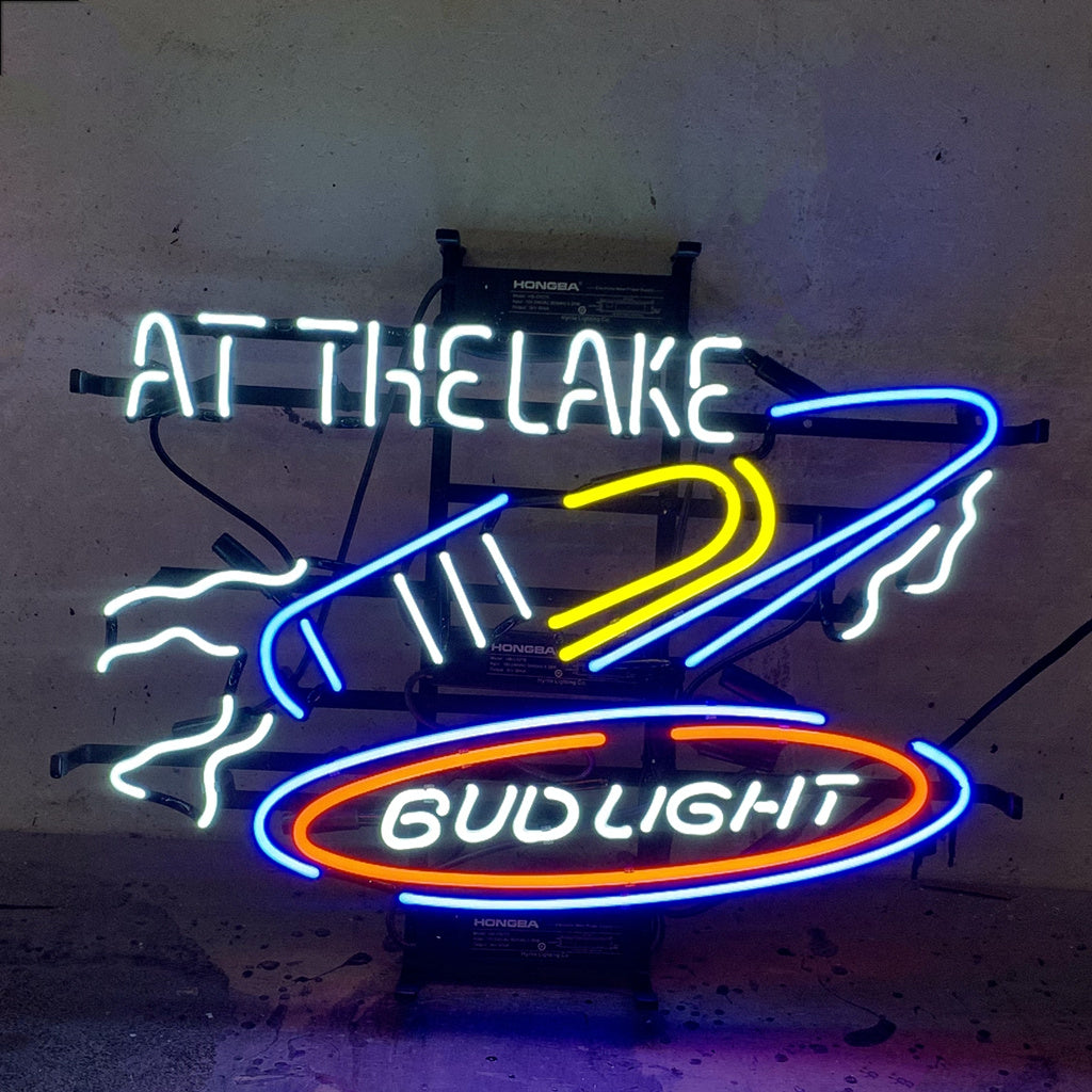 Yacht At The Lake Bud Light Neon Light Sign glowing indoors with yacht and lake design on metal grid backing