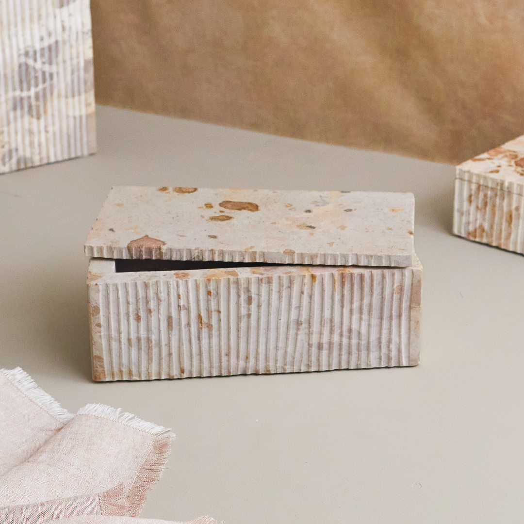 Rectangular marble box with a textured ribbed pattern on the sides and a flat lid featuring brown and beige speckles, displayed on a neutral surface.