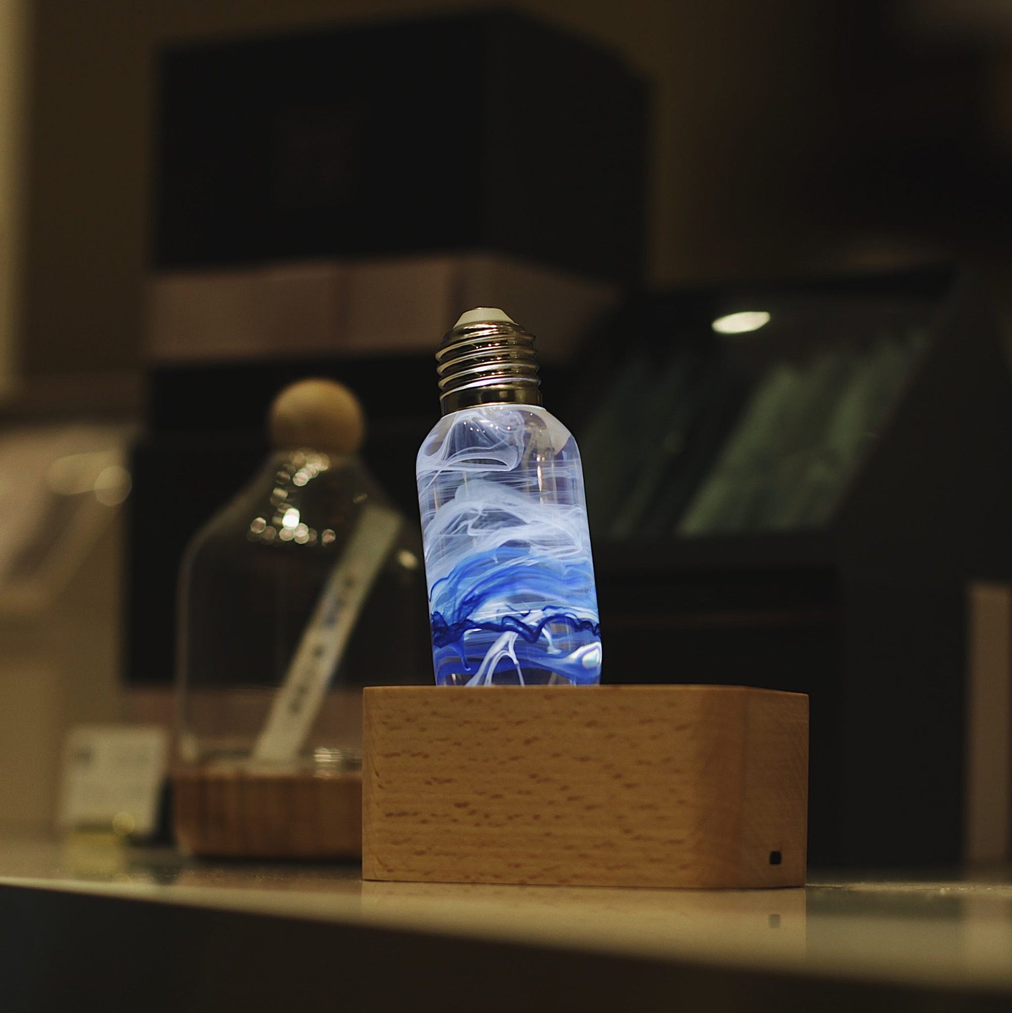 Three handcrafted resin LED bulbs with unique color patterns, shown in a 3-pack