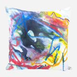 Square pillow with abstract watercolor design featuring swirling blue, red, yellow, and orange brushstrokes on a white background