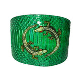 Emerald green snake collar with textured scales and two gold-tone rhinestone alligators with red eyes intertwined on the front.
