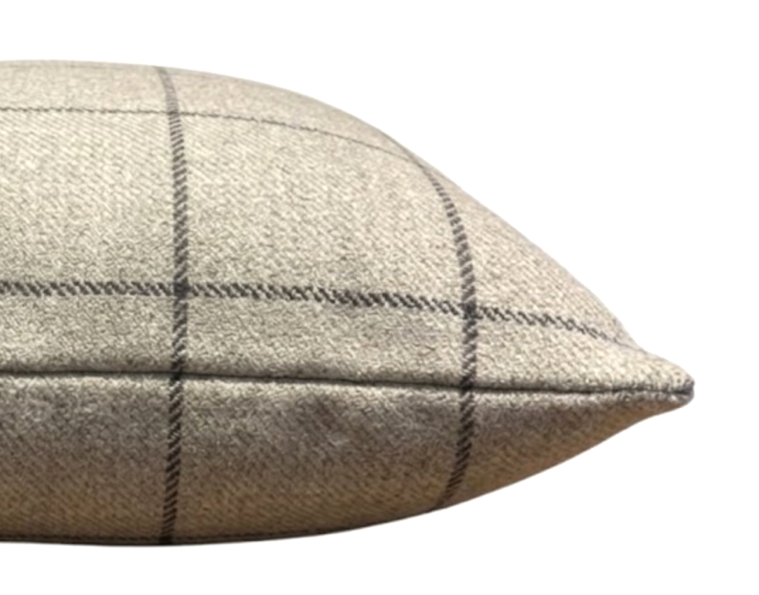 Close-up of a beige wool pillow cover with a Malt Brown large check pattern and a pointed edge seam detail.