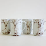 Four white ceramic mugs with brown birch tree illustrations, each featuring carved heart designs with custom initials inside, displayed on a white surface.