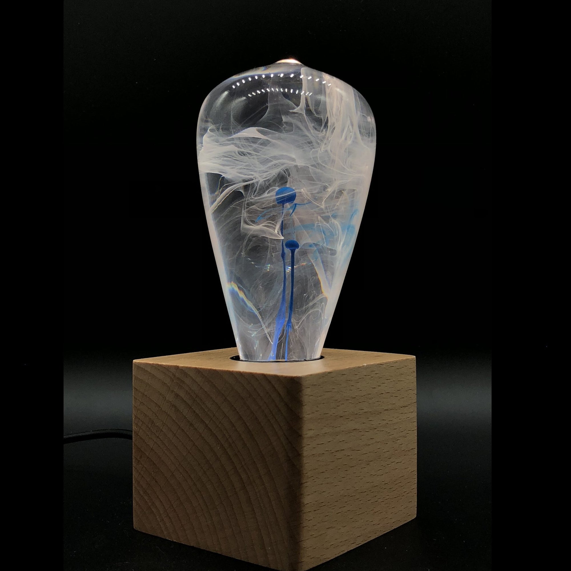 EP Light BlueDrop Resin Table Lamp with wooden base and glowing LED bulb