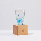 EP Light BlueDrop Resin Table Lamp with wooden base and glowing LED bulb