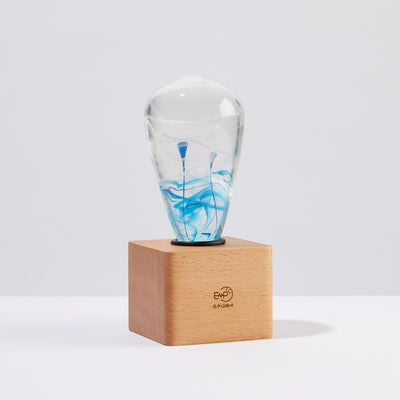 EP Light BlueDrop Resin Table Lamp with wooden base and glowing LED bulb