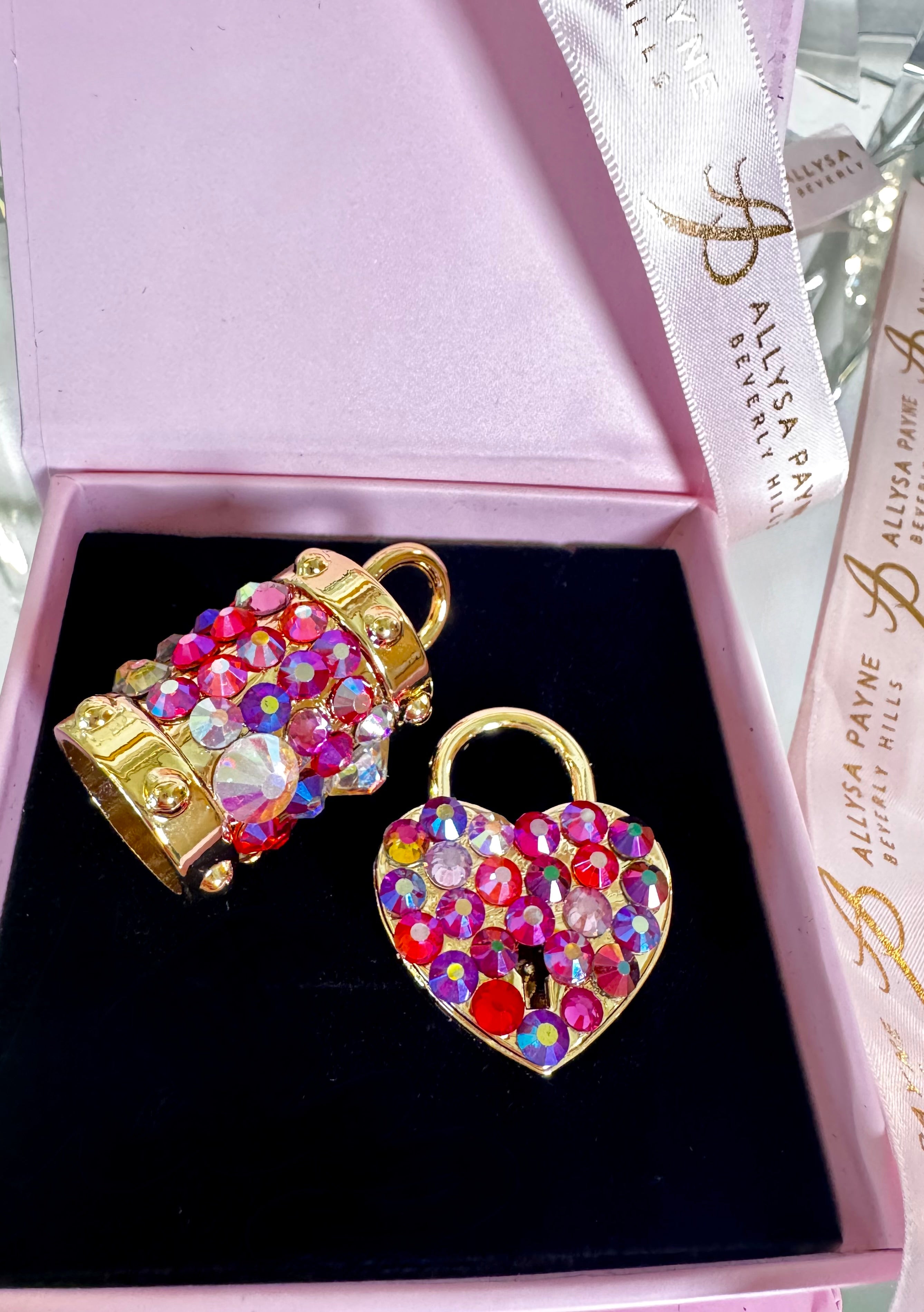 Blush Swarovski crystal heart locket and matching bell charm with polished gold-tone hardware