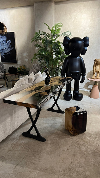 Handcrafted resin live edge console table made of aged linden wood with aluminum legs in a foyer setting