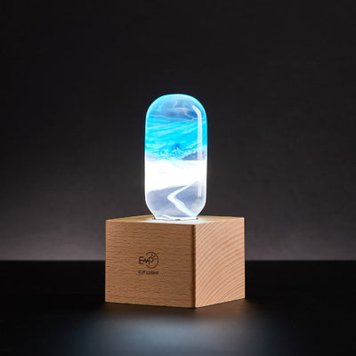 Three handcrafted resin LED bulbs with unique color patterns, shown in a 3-pack