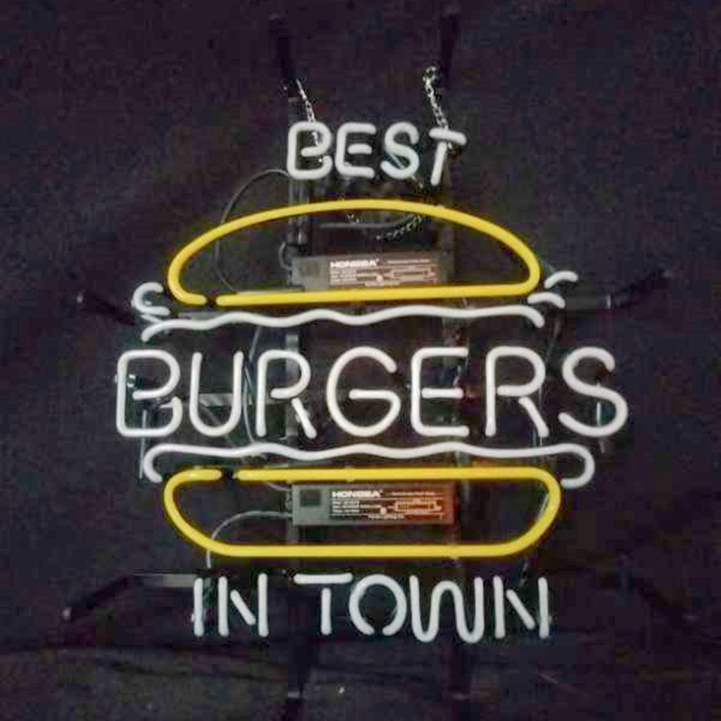 Neon sign shaped like a burger with white letters reading 'BEST BURGERS IN TOWN' and yellow lines representing the bun on a dark background