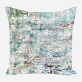 Square pillow with an abstract design featuring muted greens, blues, and white in a textured, painterly pattern with hints of circular shapes.
