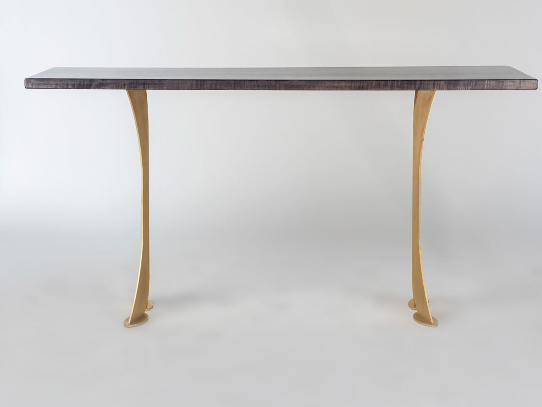 Rectangular black tabletop sofa table with two curved gold-colored split legs, shown against a plain white background.