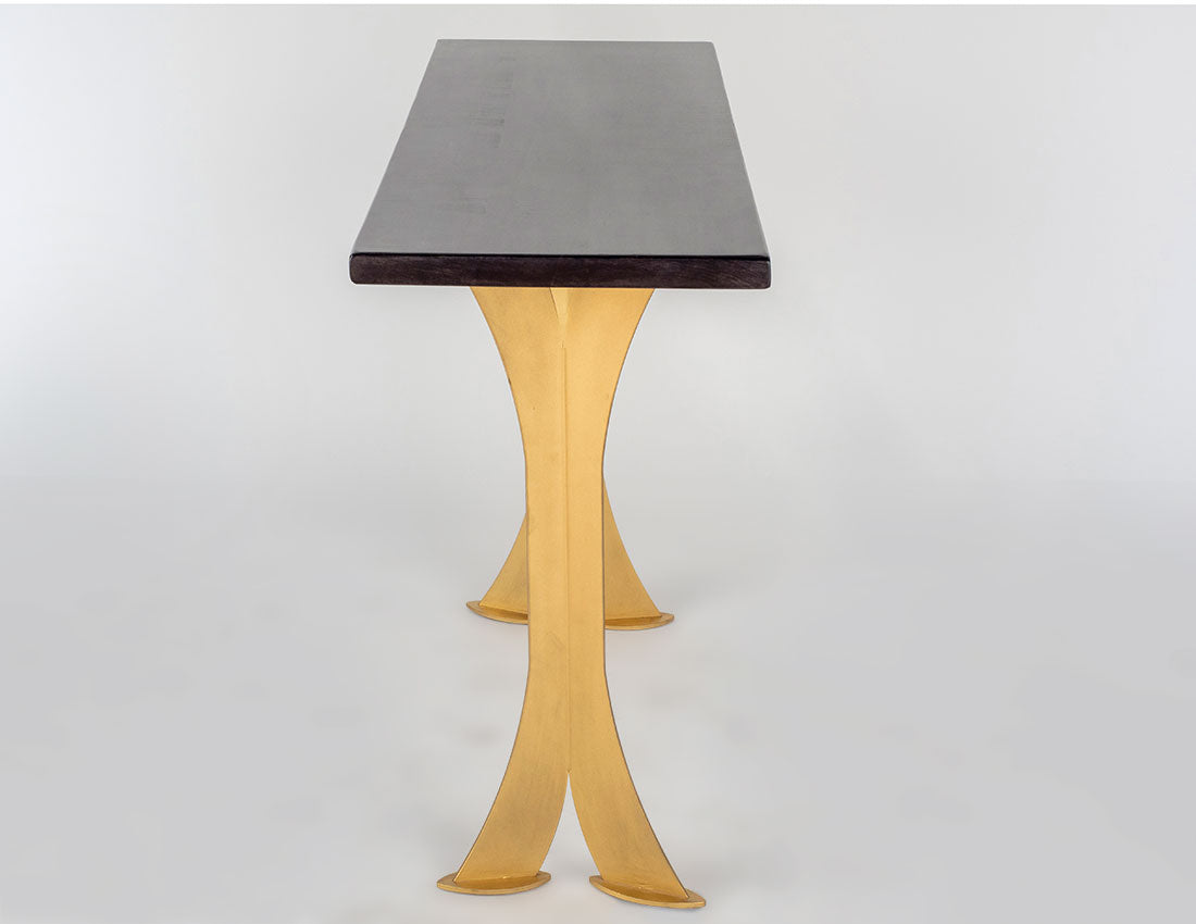 Rectangular black wooden sofa table with elegant curved gold metal legs in a split design, shown from the front against a white background.