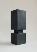Matte black squared vase composed of two stacked rectangular blocks with slight texture on a neutral background.