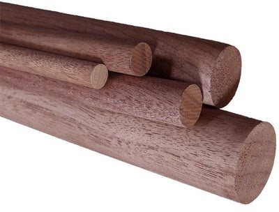 Stacked black walnut dowel rods showing smooth unfinished wood surfaces