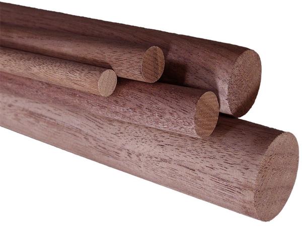 Stacked black walnut dowel rods showing smooth unfinished wood surfaces