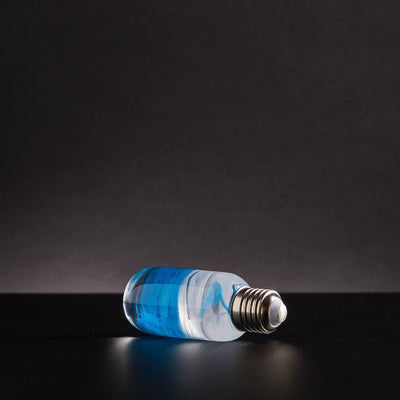 Three handcrafted resin LED bulbs with unique color patterns, shown in a 3-pack