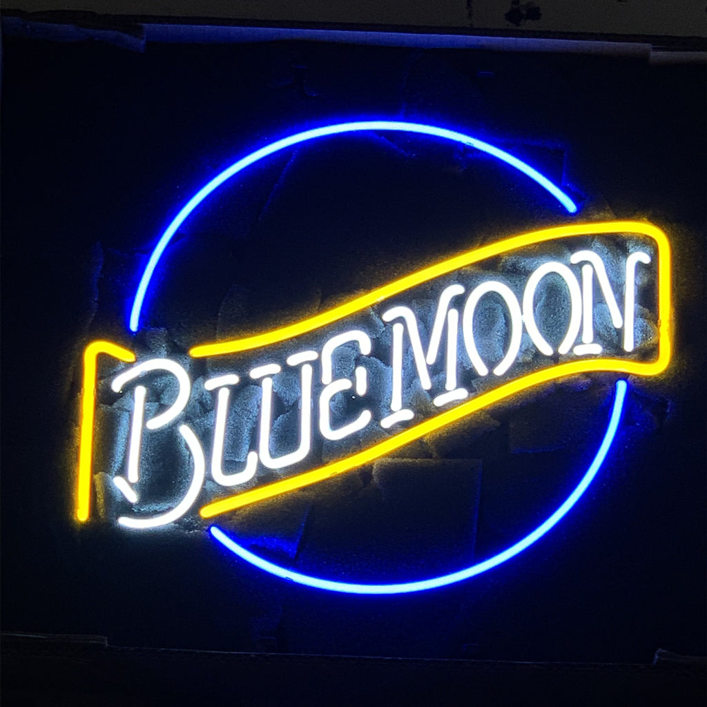 Blue Moon Beer Neon Light Sign glowing against a dark wall