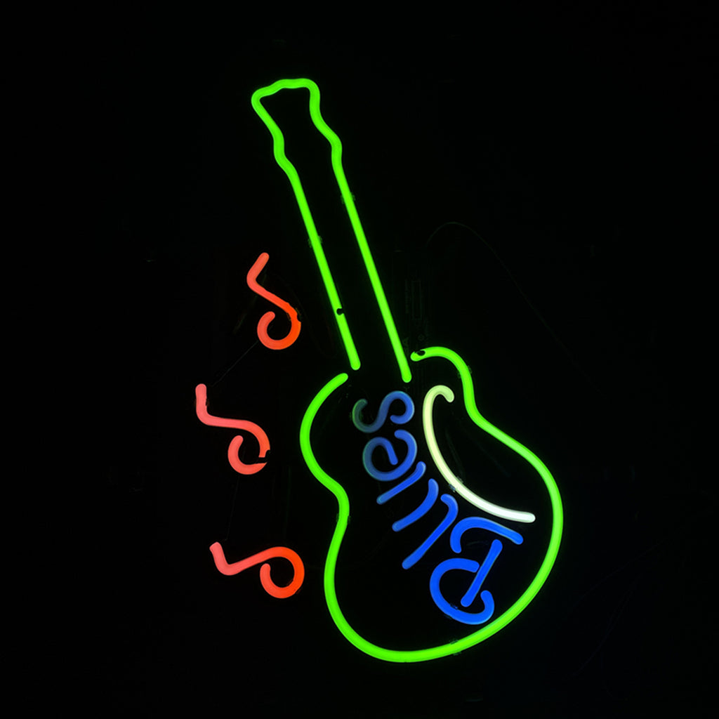Green neon outline of an electric guitar with the word 'Blues' in blue neon inside the body and three red neon music notes to the left.