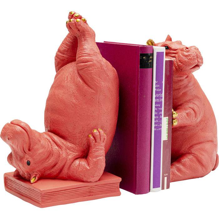 Pair of pink hippopotamus bookends, one lying on its back with golden toenails, the other sitting upright, holding books between them.