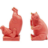Pair of pink hippopotamus bookends with gold accents on ears, fingers, and toes, one hippo standing upside down on its back and the other sitting upright.