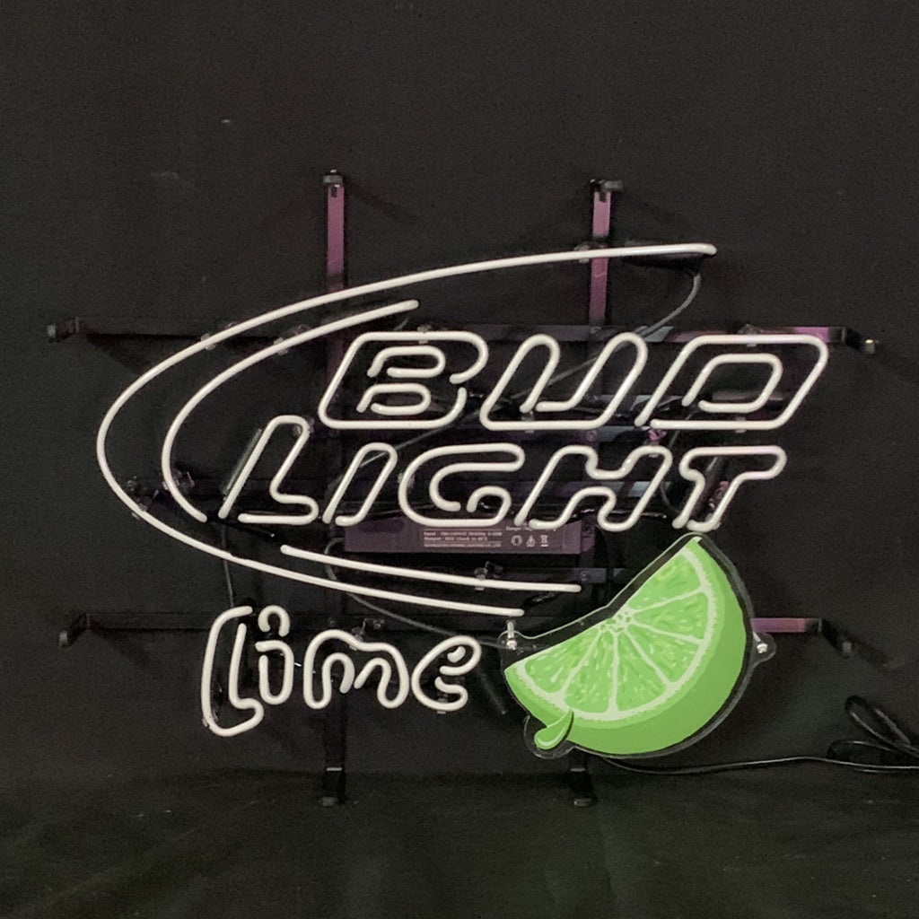 Neon sign with white tubing spelling 'BUD LIGHT lime' and a green lime slice illustration on a black background.